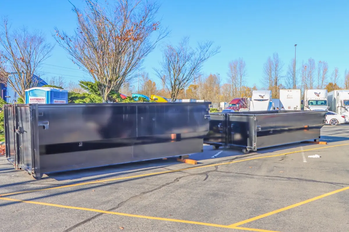 Professional dumpster rental service with roll-off container on residential driveway in Reedsburg